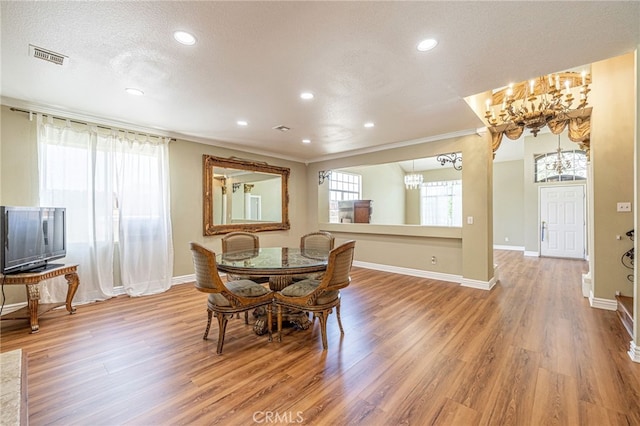 5808 Monterey Pl, Palmdale, CA 93552 - dining area featuring a chandelier, light wood-style floors, recessed lighting, ornamental molding, and a textured ceiling