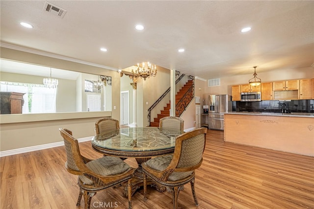 5808 Monterey Pl, Palmdale, CA 93552 - dining room with a chandelier, light wood finished floors, ornamental molding, recessed lighting, and stairs