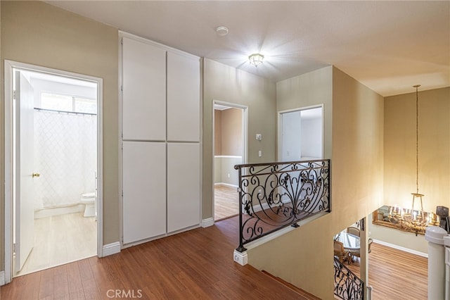 5808 Monterey Pl, Palmdale, CA 93552 - corridor with an upstairs landing and wood finished floors