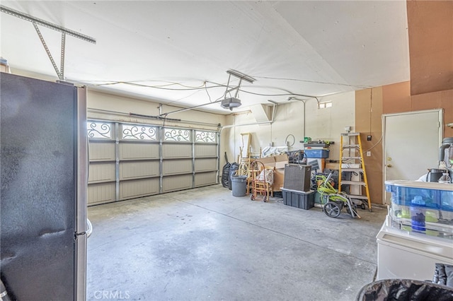 5808 Monterey Pl, Palmdale, CA 93552 - garage featuring freestanding refrigerator and a garage door opener