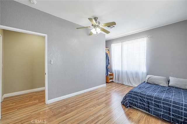 5808 Monterey Pl, Palmdale, CA 93552 - bedroom with wood finished floors, a ceiling fan, and a textured wall