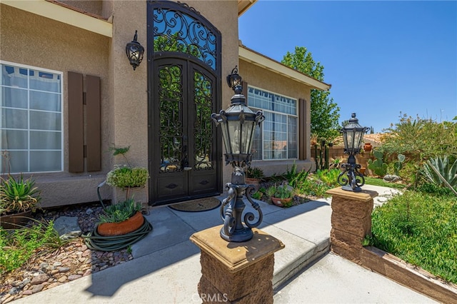 5808 Monterey Pl, Palmdale, CA 93552 - doorway to property with french doors and stucco siding