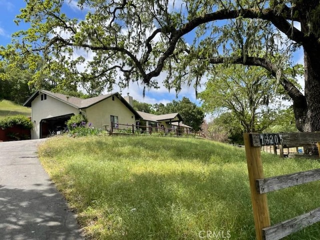 13205 Santa Lucia Rd, Atascadero, CA 93422 - view of home's exterior with stucco siding, a garage, and driveway