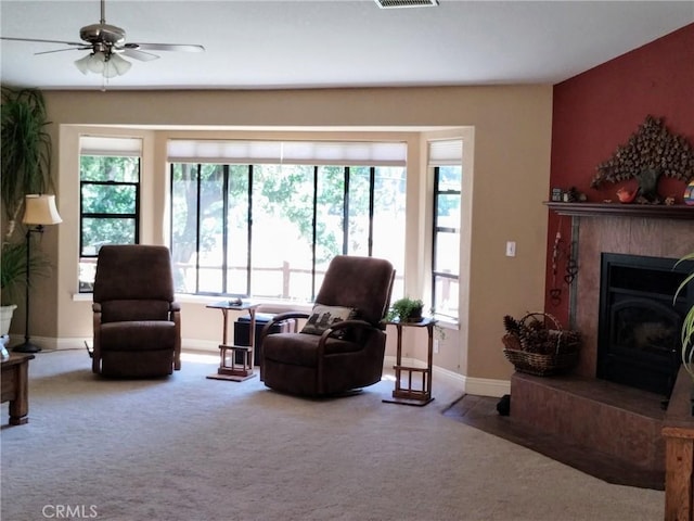 13205 Santa Lucia Rd, Atascadero, CA 93422 - carpeted living area with a ceiling fan and a fireplace with raised hearth