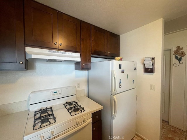 14194 Old Field Ave, Fontana, CA 92337 - kitchen with white appliances, under cabinet range hood, light countertops, and dark brown cabinetry
