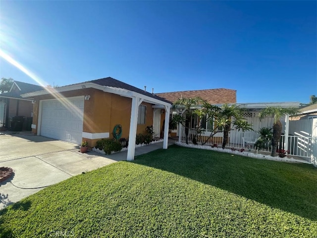 14194 Old Field Ave, Fontana, CA 92337 - back of house with a yard, a garage, concrete driveway, and stucco siding