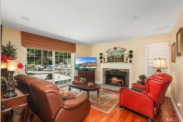 28606 Vista Ladera, Laguna Niguel, CA 92677 - living area featuring a stone fireplace, wood finished floors, and a textured ceiling