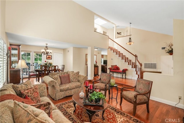 28606 Vista Ladera, Laguna Niguel, CA 92677 - living area featuring wood finished floors, stairway, high vaulted ceiling, and a chandelier