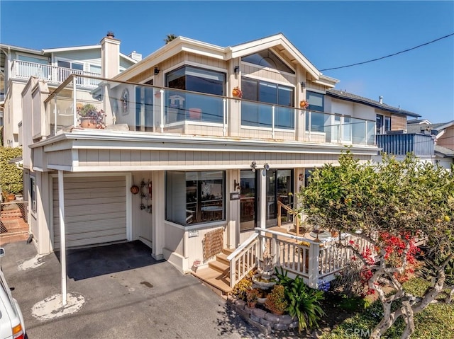 3277 Ocean Blvd, Cayucos, CA 93430 - view of front of house with a balcony, covered porch, an attached garage, and asphalt driveway
