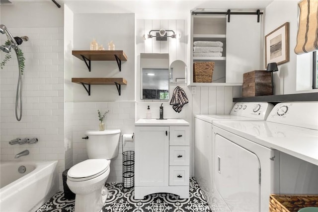 4934 Tippitoe Ln, Forest Ranch, CA 95942 - bathroom featuring washing machine and dryer, tile patterned floors, vanity, bathing tub / shower combination, and tile walls