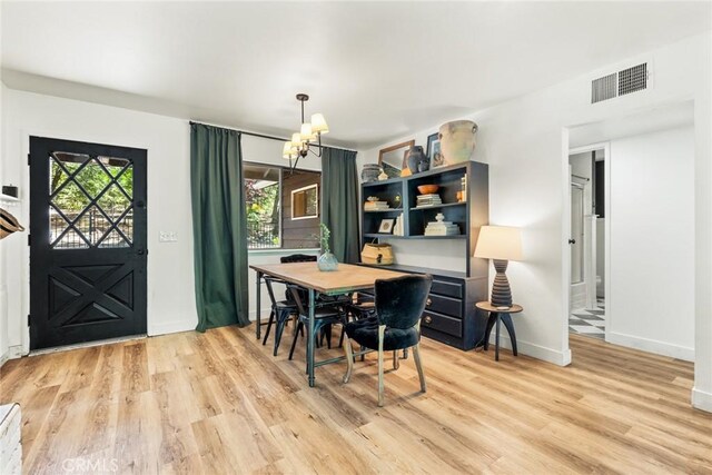 4934 Tippitoe Ln, Forest Ranch, CA 95942 - dining space with healthy amount of natural light, a chandelier, and light wood-style flooring