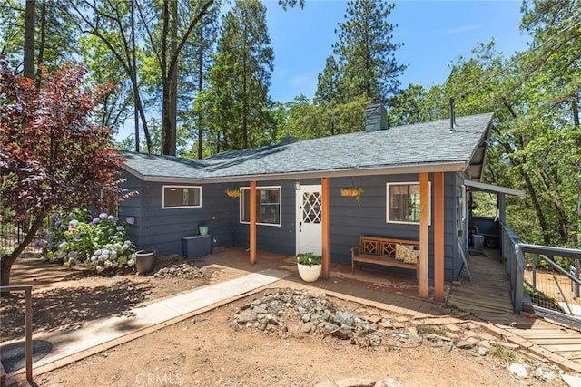4934 Tippitoe Ln, Forest Ranch, CA 95942 - view of front of house featuring a chimney, a porch, and a shingled roof