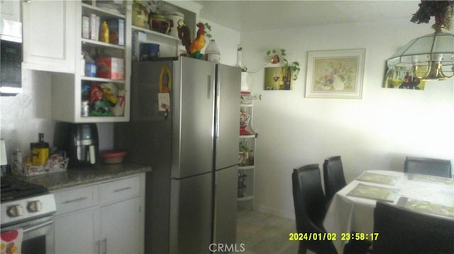 1033 Chapel Dr, Bakersfield, CA 93304 - kitchen with stainless steel appliances and white cabinetry
