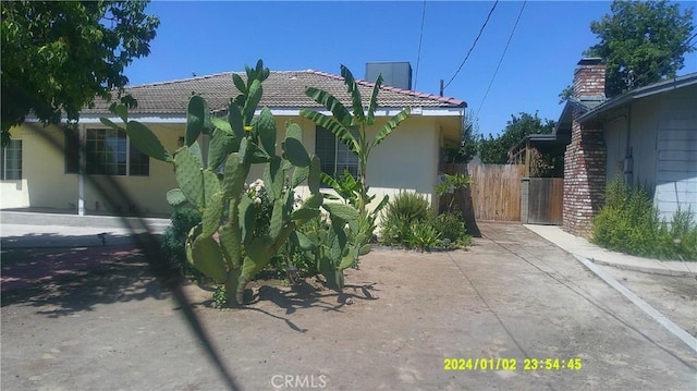 1033 Chapel Dr, Bakersfield, CA 93304 - view of home's exterior with stucco siding and a tile roof