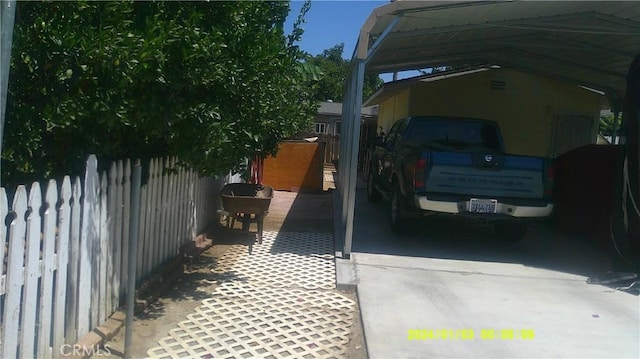 1033 Chapel Dr, Bakersfield, CA 93304 - view of vehicle parking featuring a carport
