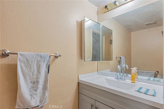 8828 Burnet Ave Unit 9, North Hills, CA 91343 - bathroom featuring vanity and a textured wall