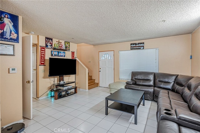 8828 Burnet Ave Unit 9, North Hills, CA 91343 - living room featuring stairway, a textured ceiling, and light tile patterned floors