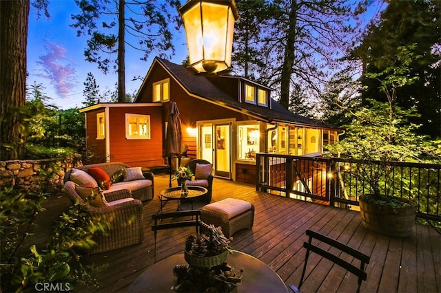 433 Milburn Rd, Lake Arrowhead, CA 92352 - back of house at dusk with a deck and an outdoor hangout area