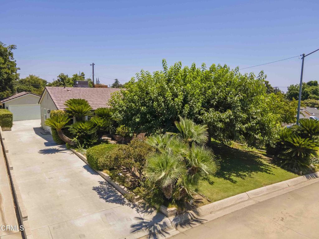 1817 Los Robles Dr, Bakersfield, CA 93306 - obstructed view of property with a tiled roof, a detached garage, and an outbuilding