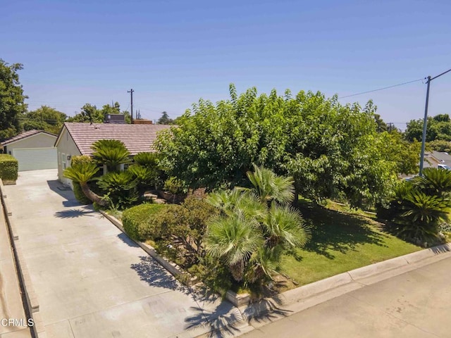1817 Los Robles Dr, Bakersfield, CA 93306 - obstructed view of property with a tiled roof, a detached garage, and an outbuilding