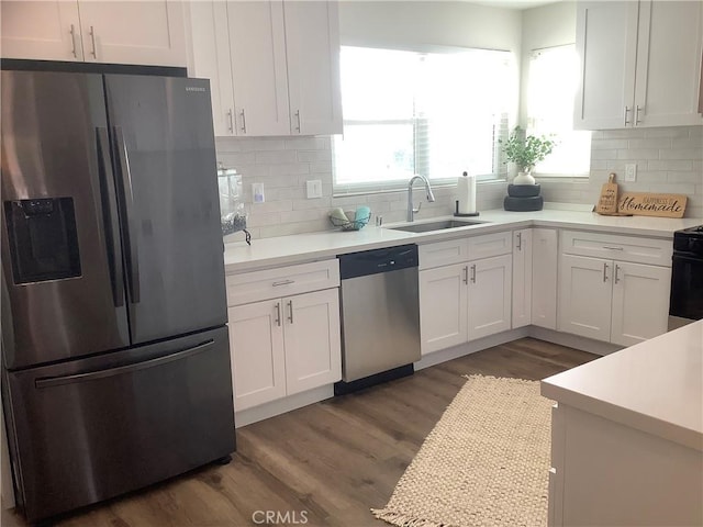 1201 W 186th St, Gardena, CA 90248 - kitchen featuring stainless steel appliances, white cabinetry, light countertops, dark wood-style floors, and decorative backsplash