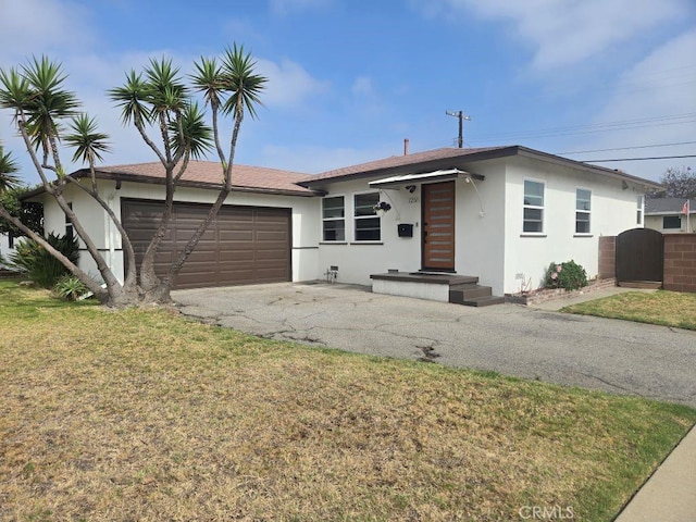 1201 W 186th St, Gardena, CA 90248 - ranch-style home featuring driveway, stucco siding, an attached garage, and a front lawn