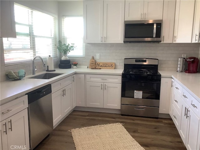 1201 W 186th St, Gardena, CA 90248 - kitchen featuring stainless steel appliances, white cabinets, dark wood-type flooring, decorative backsplash, and light countertops
