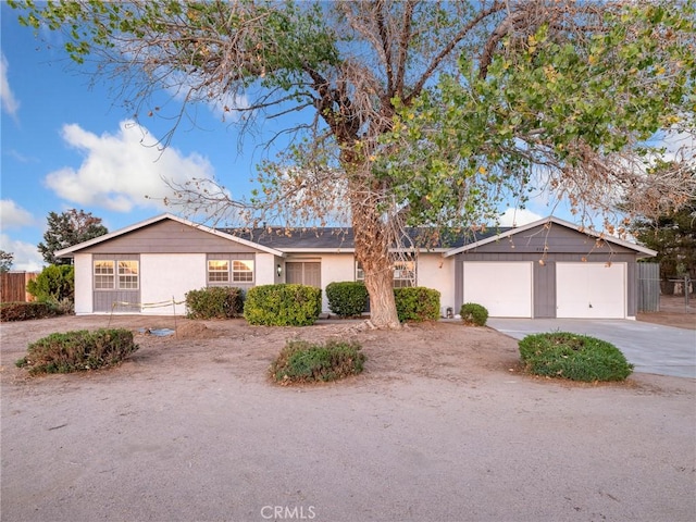 9383 11th Ave, Hesperia, CA 92345 - ranch-style house with concrete driveway, an attached garage, and stucco siding