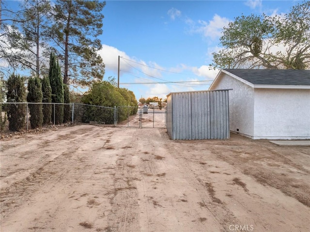 9383 11th Ave, Hesperia, CA 92345 - view of dirt / gravel road with a gate and a gated entry