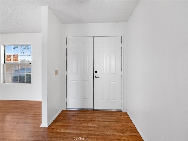 9383 11th Ave, Hesperia, CA 92345 - foyer entrance featuring wood finished floors and a textured ceiling