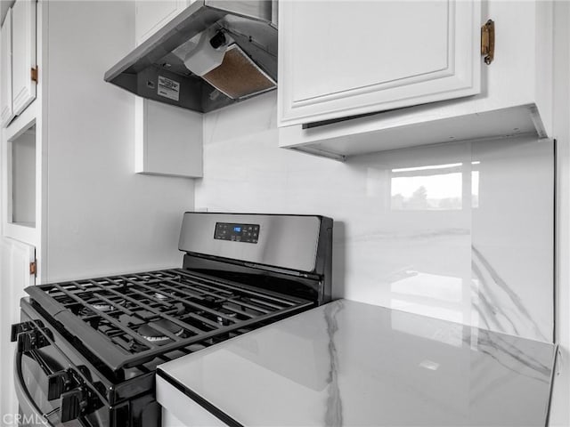 9383 11th Ave, Hesperia, CA 92345 - kitchen with stainless steel gas stove, wall chimney exhaust hood, white cabinetry, and light countertops