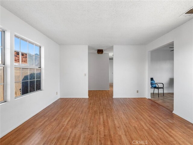9383 11th Ave, Hesperia, CA 92345 - empty room featuring light wood-style flooring and a textured ceiling