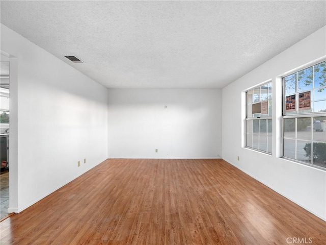 9383 11th Ave, Hesperia, CA 92345 - spare room featuring wood finished floors and a textured ceiling