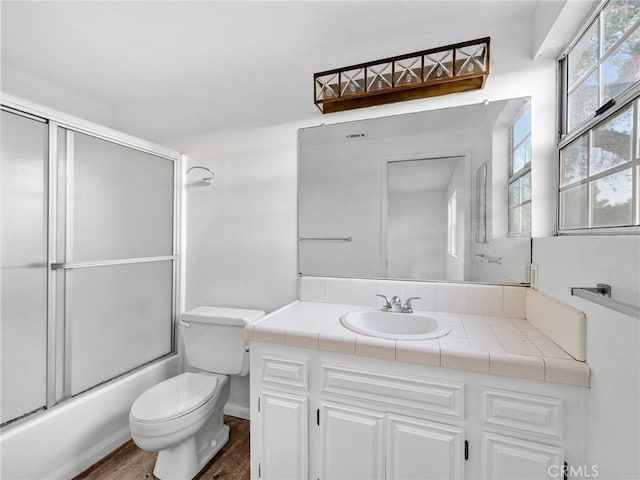 9383 11th Ave, Hesperia, CA 92345 - bathroom with vanity, wood finished floors, and combined bath / shower with glass door
