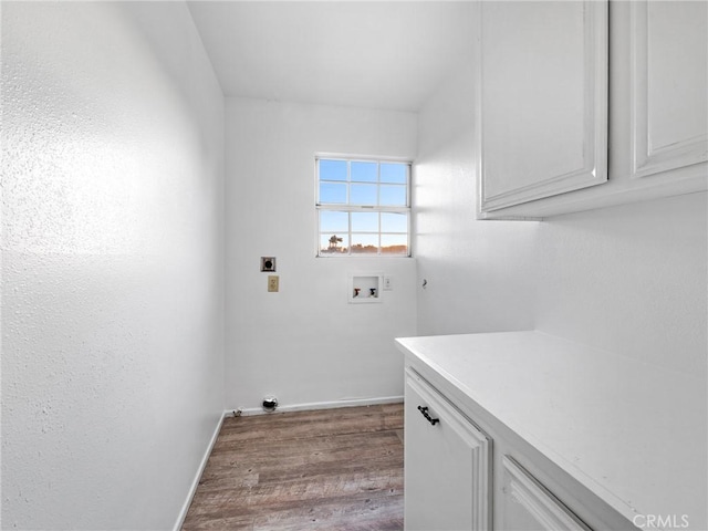 9383 11th Ave, Hesperia, CA 92345 - laundry area featuring electric dryer hookup, wood finished floors, cabinet space, and washer hookup