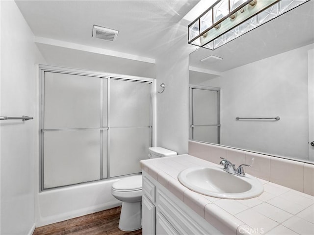 9383 11th Ave, Hesperia, CA 92345 - bathroom with vanity, wood finished floors, and combined bath / shower with glass door