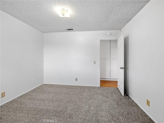 9383 11th Ave, Hesperia, CA 92345 - empty room featuring carpet flooring, a textured ceiling, and a smoke detector