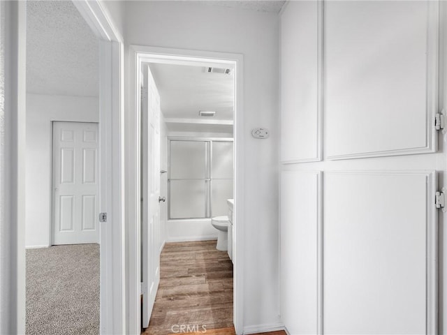 9383 11th Ave, Hesperia, CA 92345 - bathroom featuring bath / shower combo with glass door and a textured ceiling