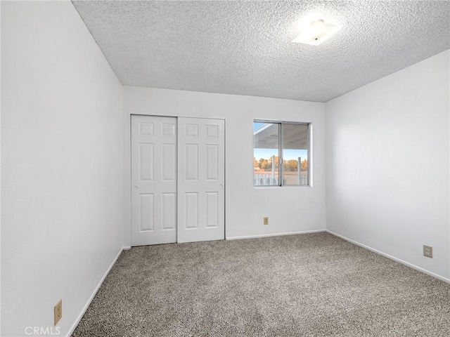 9383 11th Ave, Hesperia, CA 92345 - unfurnished bedroom with a textured ceiling, carpet flooring, and a closet