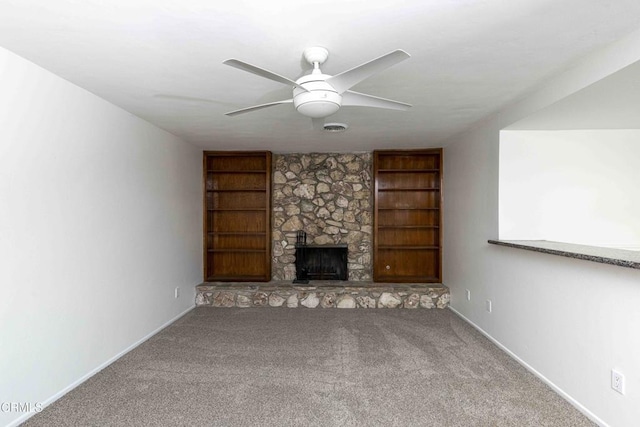 4713 Perris Way, Bakersfield, CA 93309 - unfurnished living room with carpet floors, a ceiling fan, built in shelves, and a fireplace