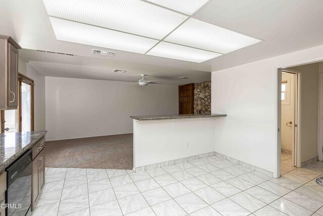 4713 Perris Way, Bakersfield, CA 93309 - kitchen featuring dishwasher, a ceiling fan, dark stone counters, light colored carpet, and a wainscoted wall