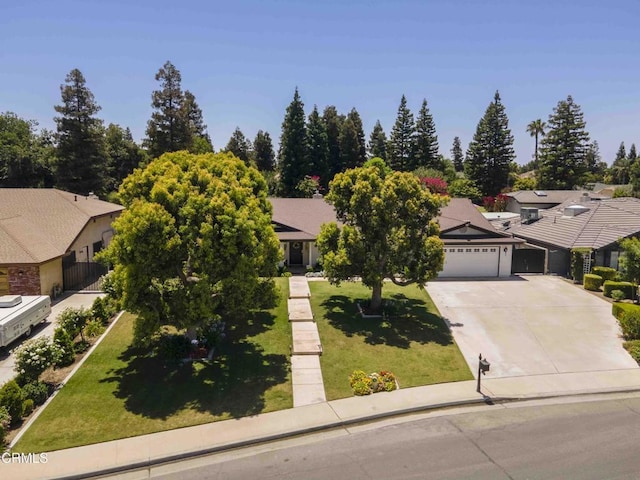 13305 San Simeon Ave, Bakersfield, CA 93314 - view of property hidden behind natural elements with a garage, a front yard, driveway, and a residential view