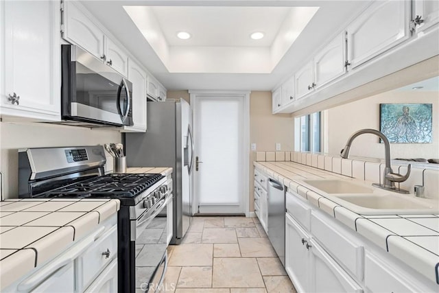 9229 Balboa Ave Unit 4, San Simeon, CA 93452 - kitchen with stainless steel appliances, tile counters, white cabinets, a raised ceiling, and recessed lighting