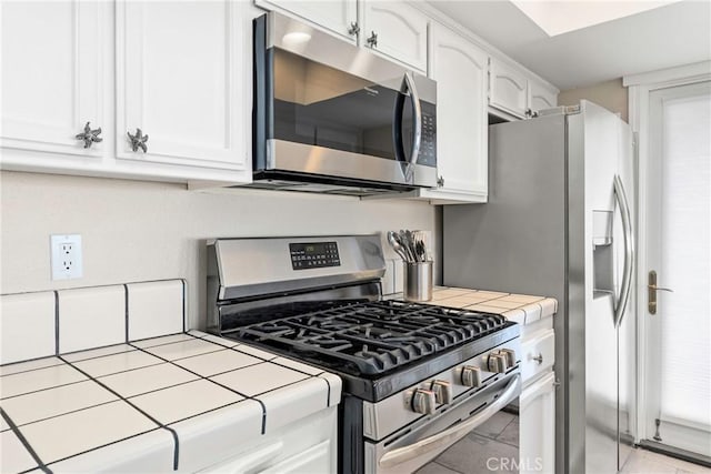 9229 Balboa Ave Unit 4, San Simeon, CA 93452 - kitchen featuring stainless steel appliances, tile countertops, and white cabinets