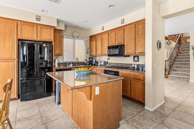 11337 Vista Elevada, San Diego, CA 92131 - kitchen with black appliances, a center island, light stone countertops, light tile patterned floors, and recessed lighting