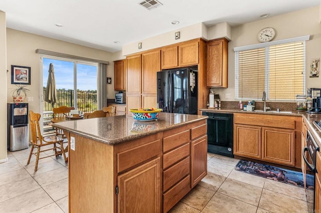 11337 Vista Elevada, San Diego, CA 92131 - kitchen featuring black appliances, light tile patterned floors, a kitchen island, brown cabinets, and recessed lighting