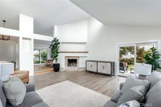 125 Park Pl, Pismo Beach, CA 93449 - living area with high vaulted ceiling, wood finished floors, and a fireplace with raised hearth