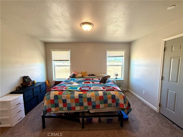 2048 10th St, Oroville, CA 95965 - carpeted bedroom featuring multiple windows and a textured ceiling