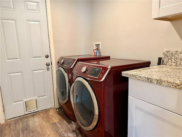 2048 10th St, Oroville, CA 95965 - laundry area featuring wood finished floors, washer and dryer, and cabinet space