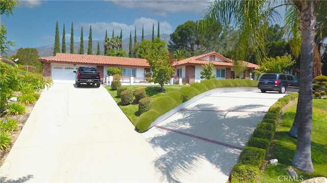 2509 Euclid E, Upland, CA 91784 - ranch-style home featuring concrete driveway, a mountain view, a tiled roof, and stucco siding